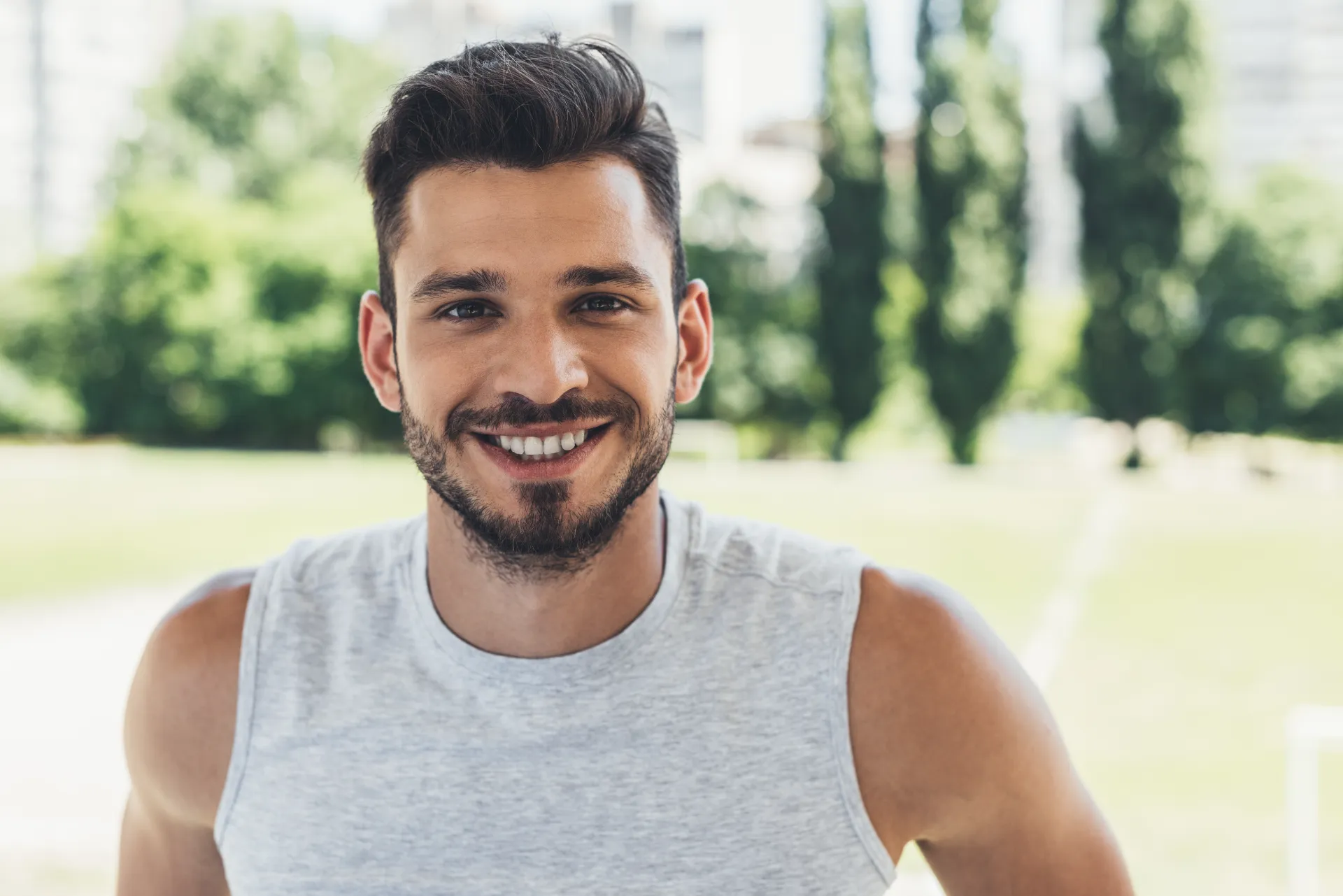 close up shot of smiling young man looking at came utc
