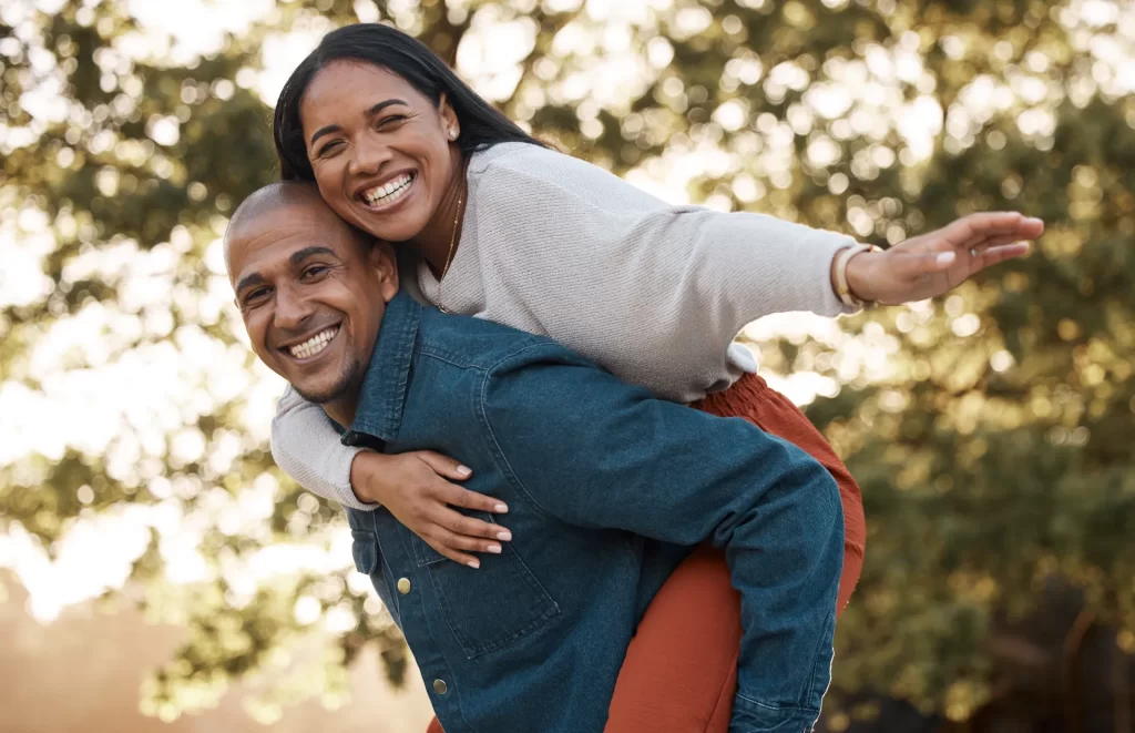 couple park and piggy back with smile portrait a utc