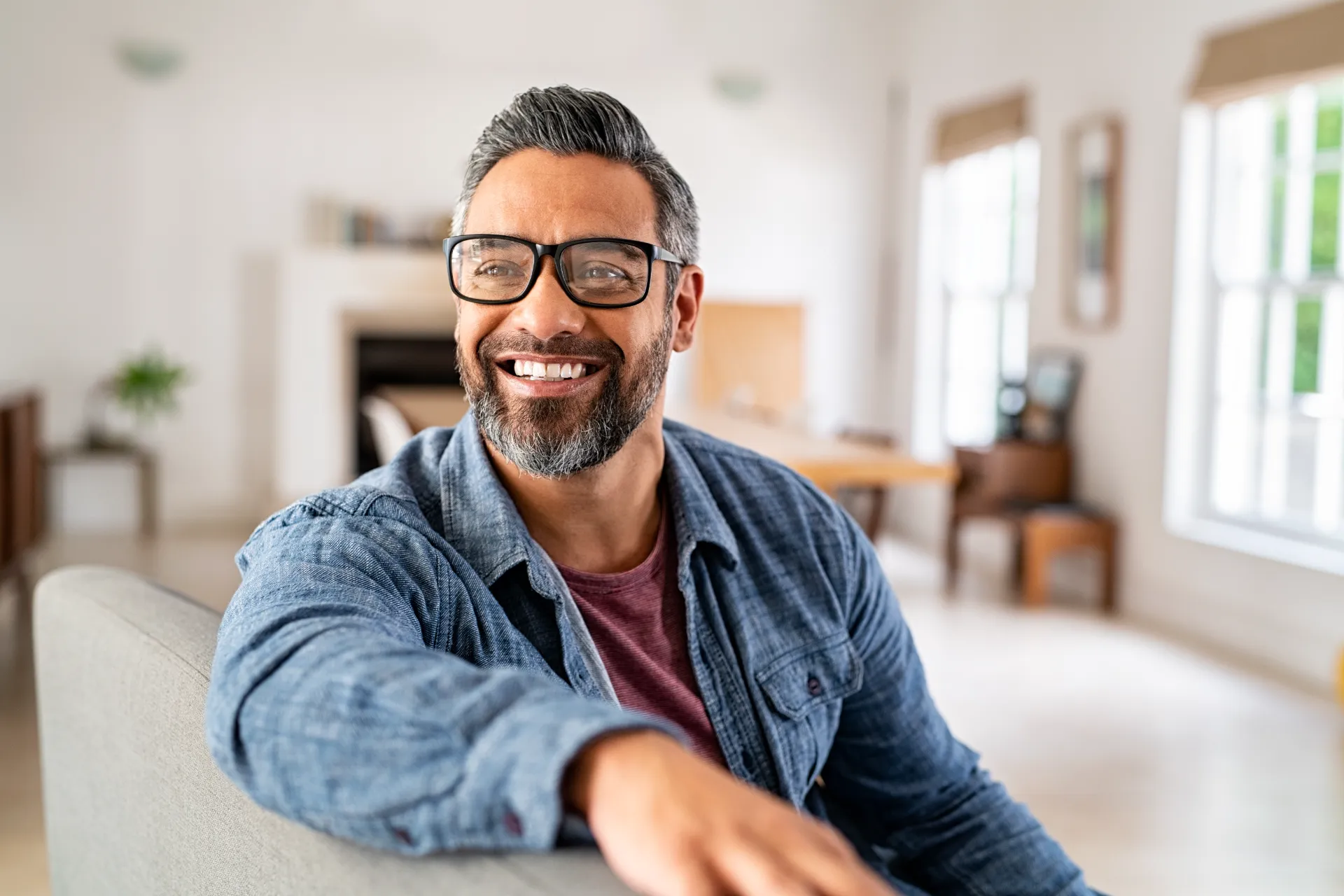 mature ethnic man wearing eyeglasses at home utc